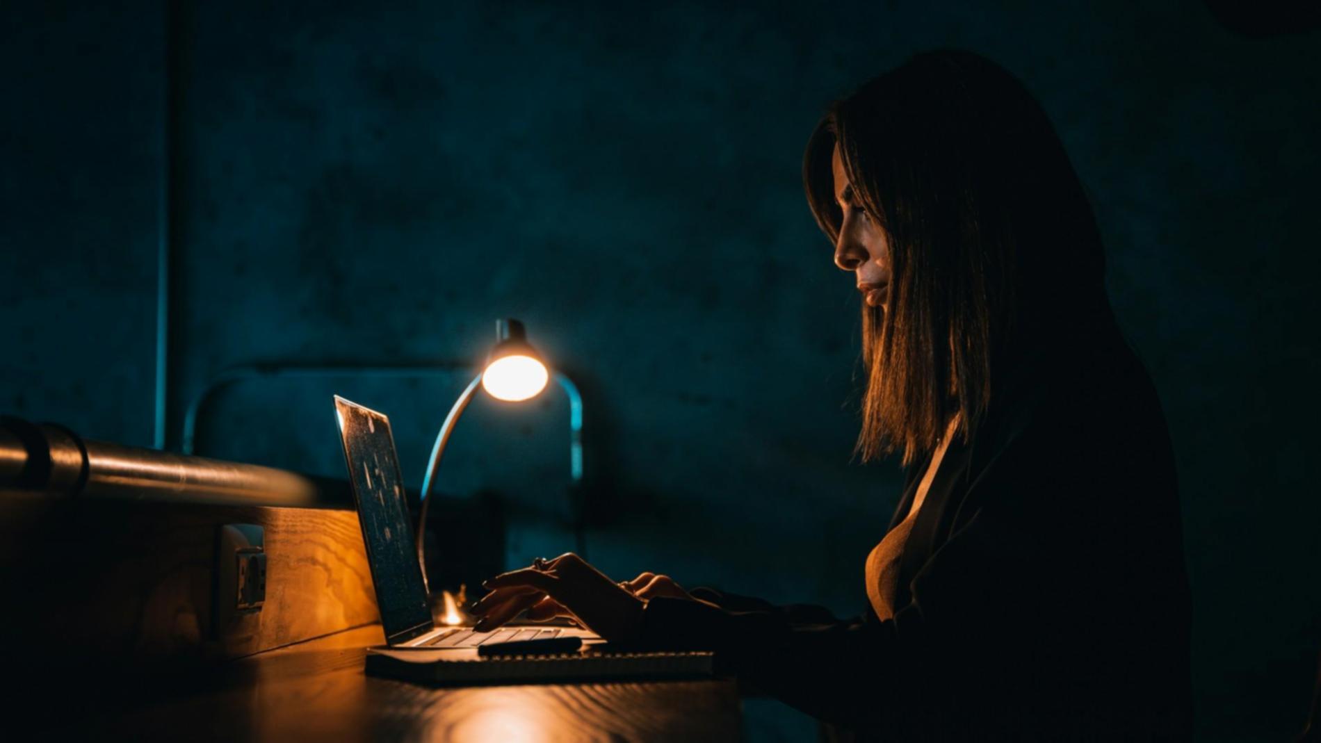 Students collaborating on coding projects in modern classroom environment